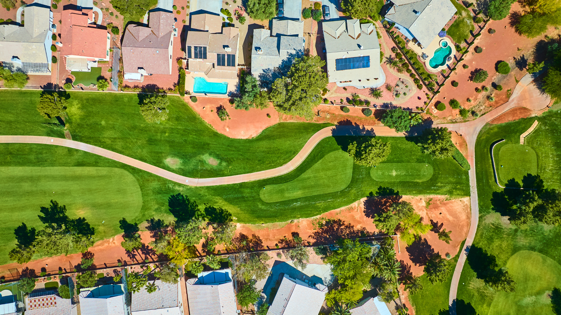 Aerial view of homes with pools along a golf course in a Southwest Florida master-planned community
