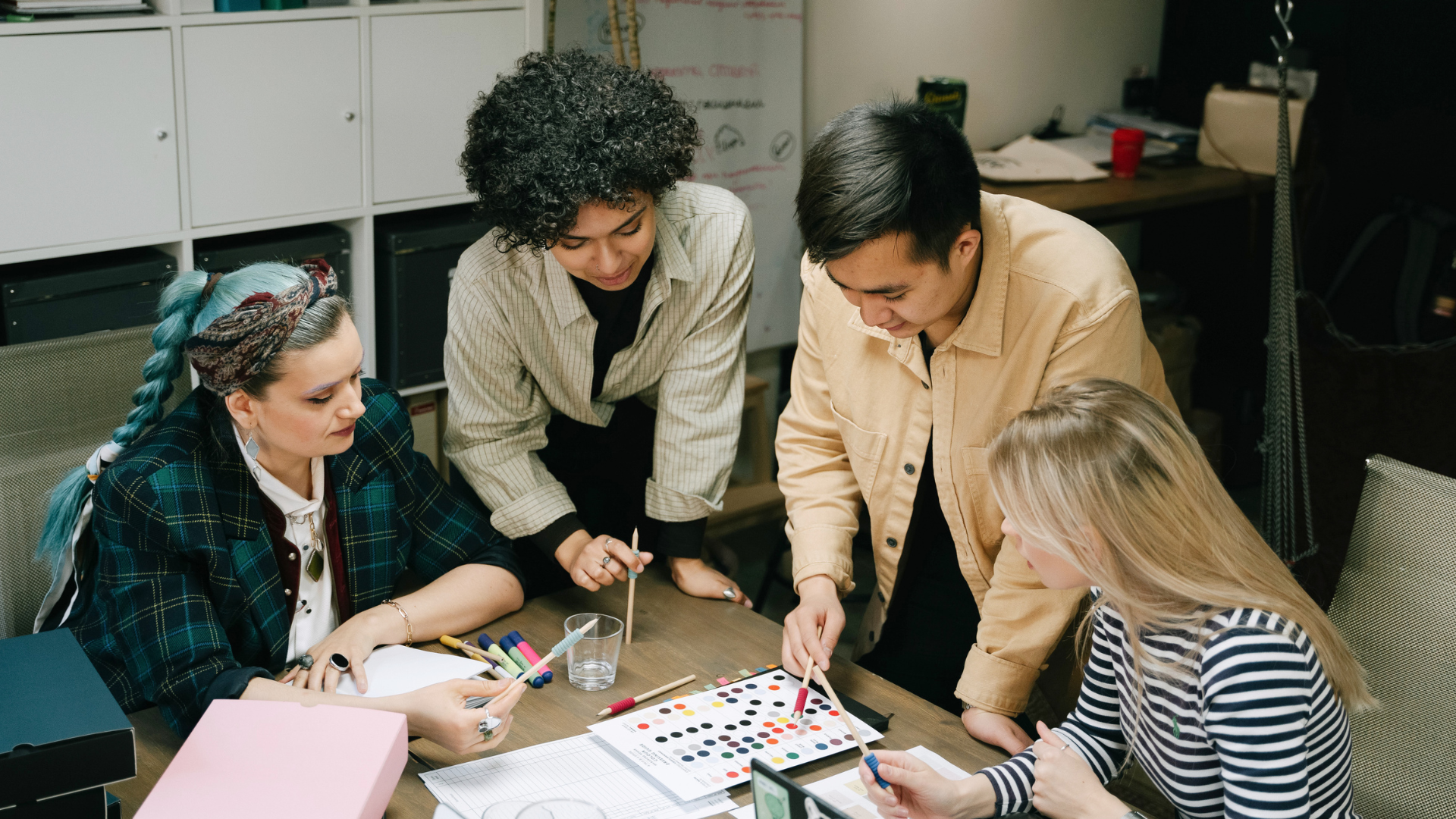 Team gathered around a table planning with documents and color samples