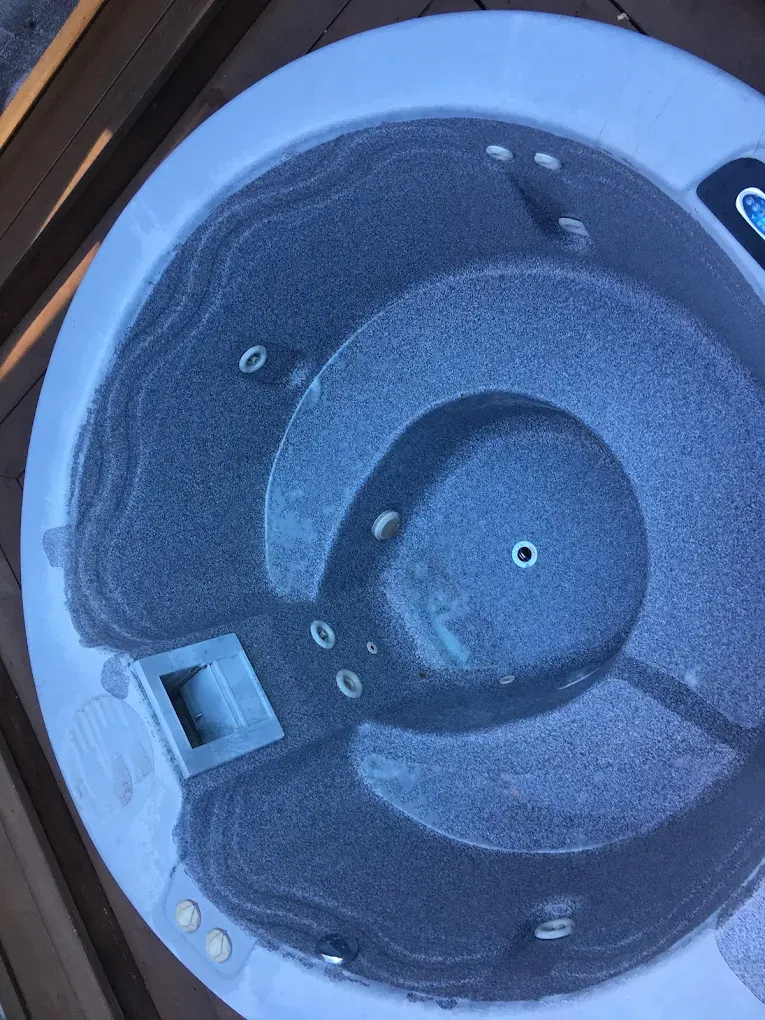 Close-up of a blue plastic container lid with a dark circular recess and small latches.