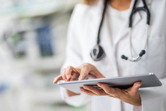 Doctor using iPad — Tampa, FL — North Tampa Foot Care Doctor using iPad — Tampa, FL — North Tampa Foot Care