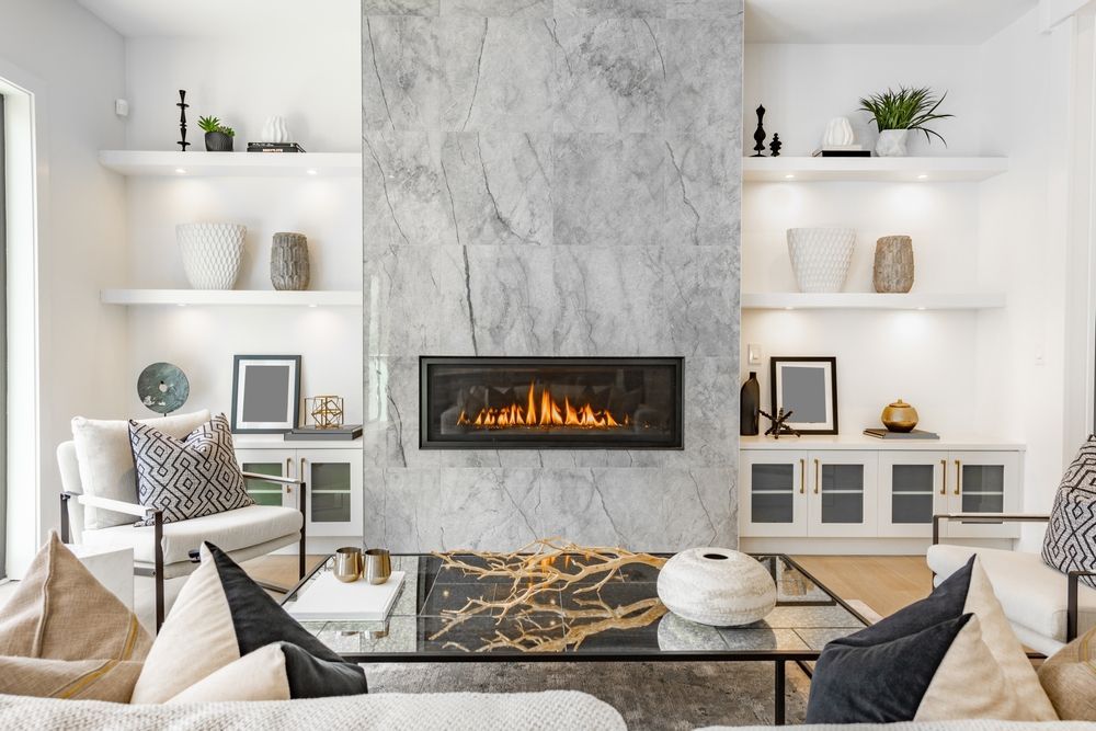 There is a fireplace in the middle of the living room.