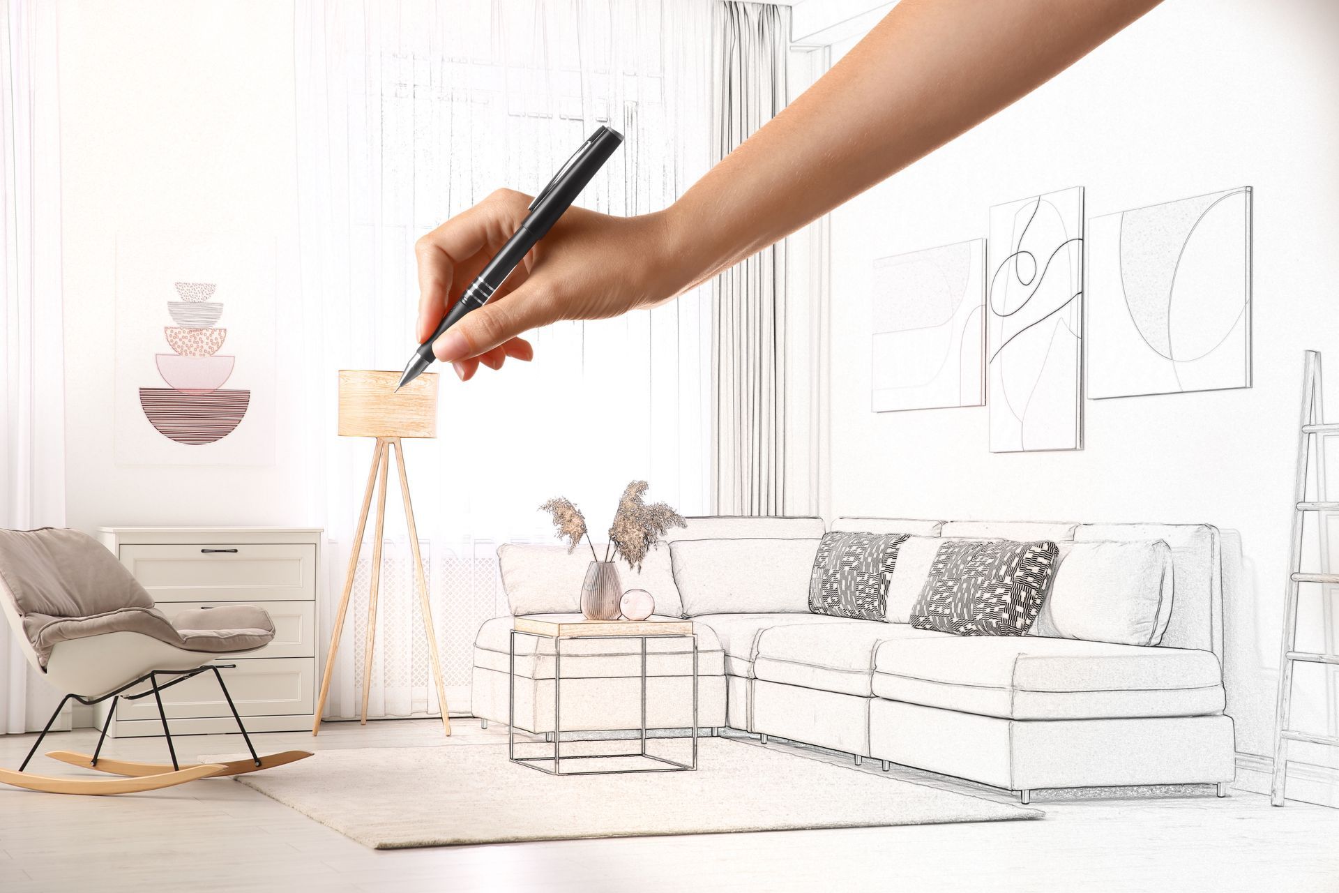 Hand sketching interior design features in a room with furniture.