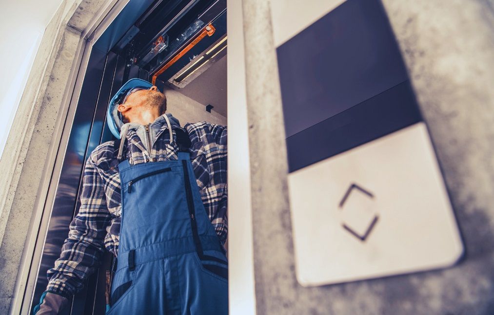 technician fixing lift doors