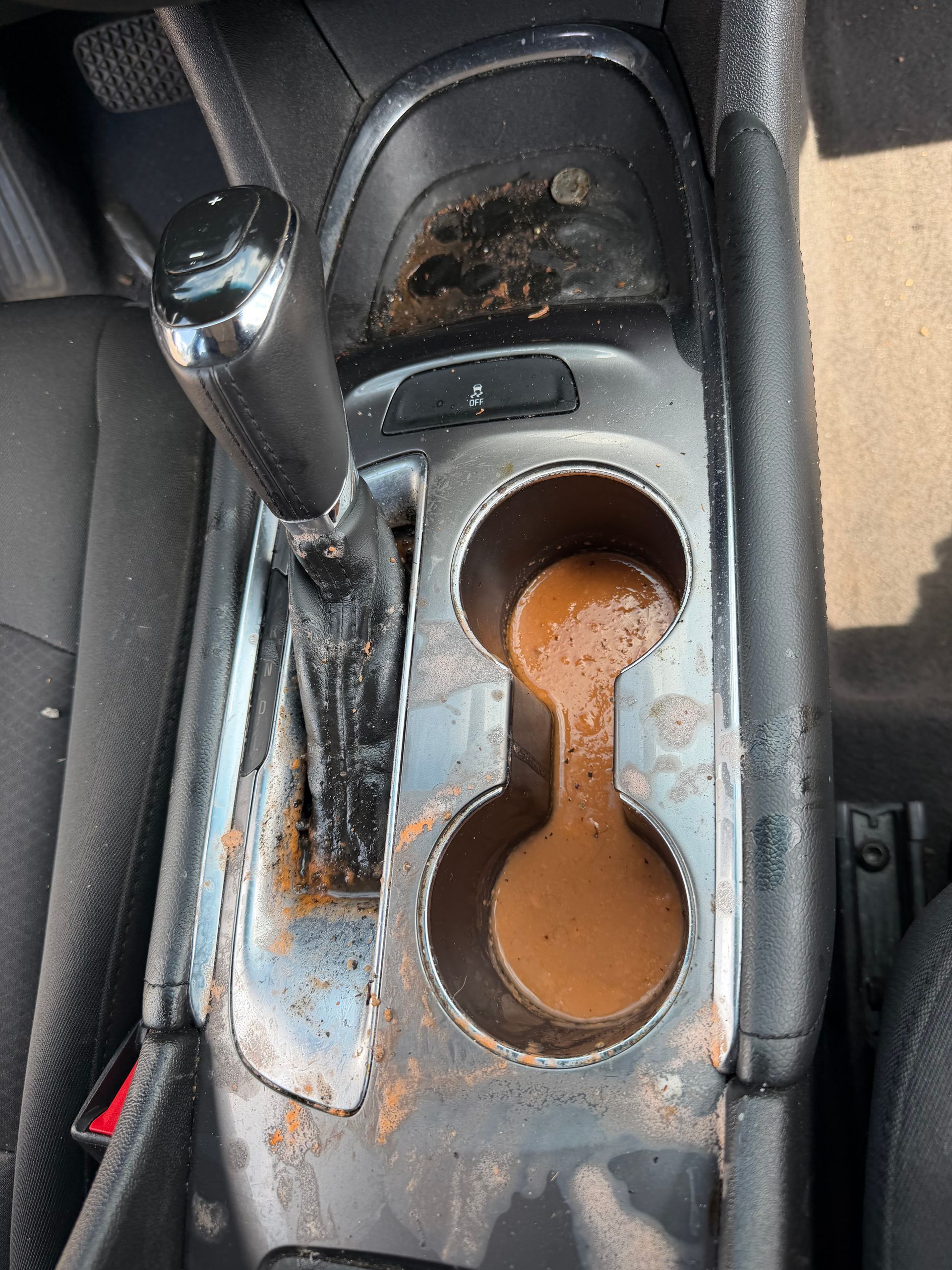 Rusty car center console cup holder with gear shift beside it