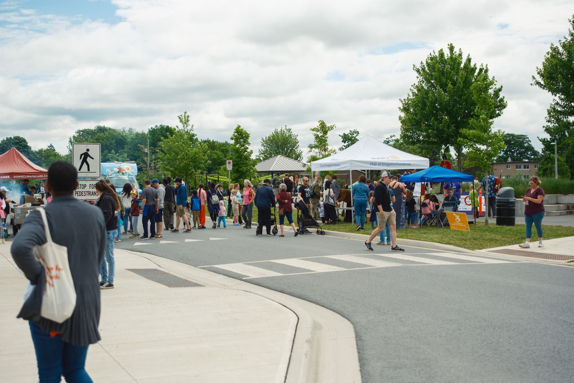 A group of people are gathered on the side of the road.
