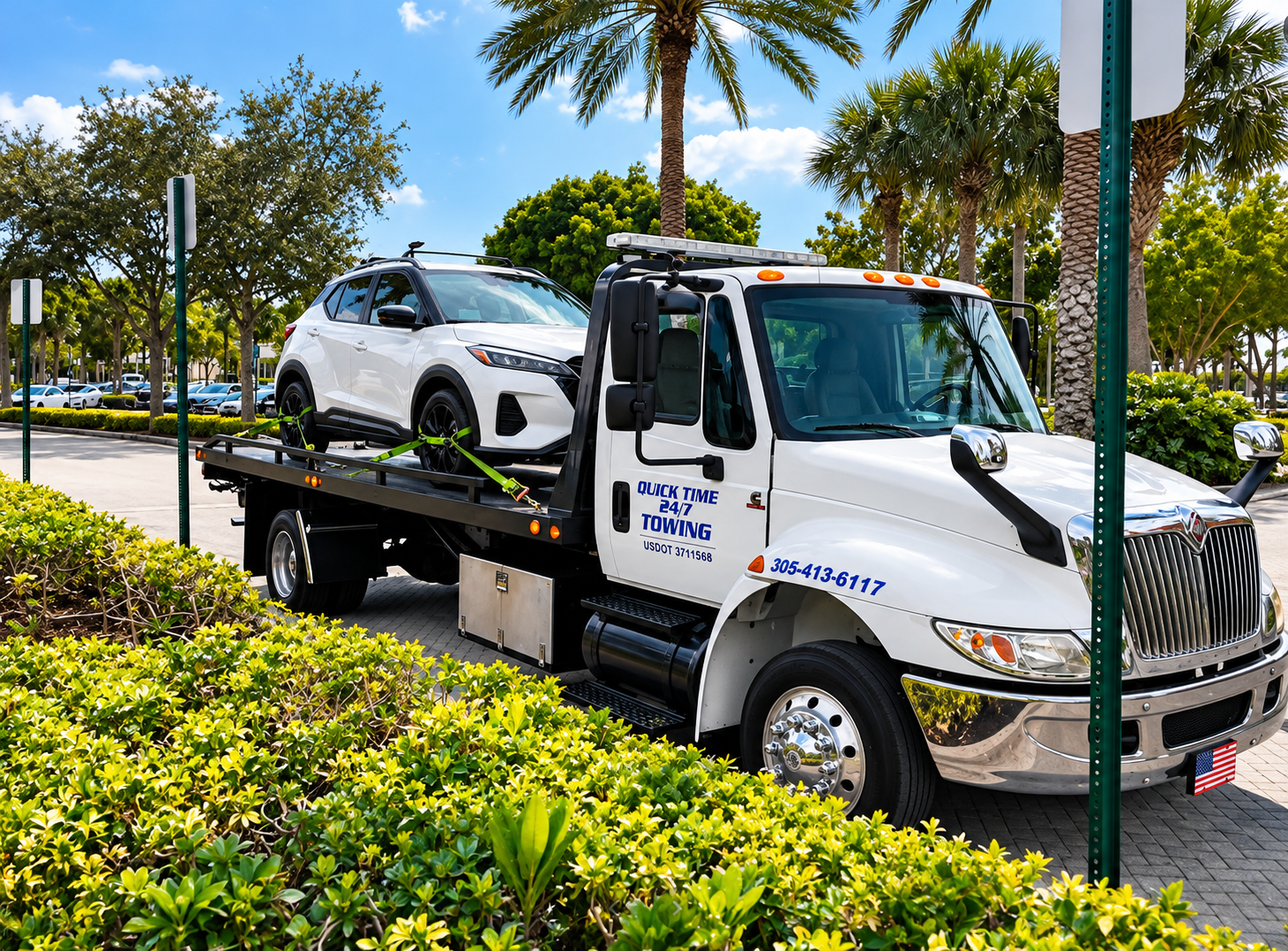 Tow truck carrying a white SUV on a sunny palm-lined street