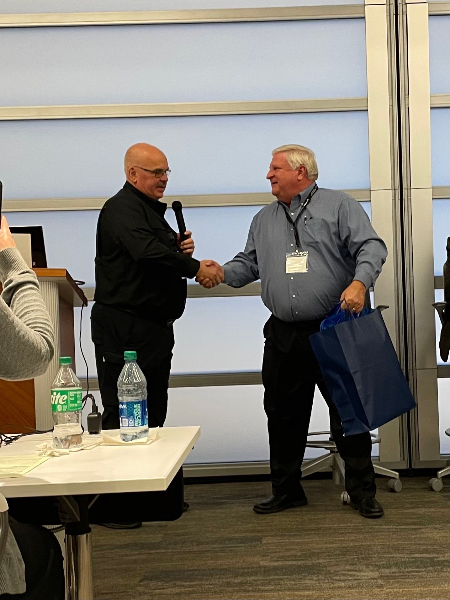 Jim oberkircker and Paul Pastusek shaking hands