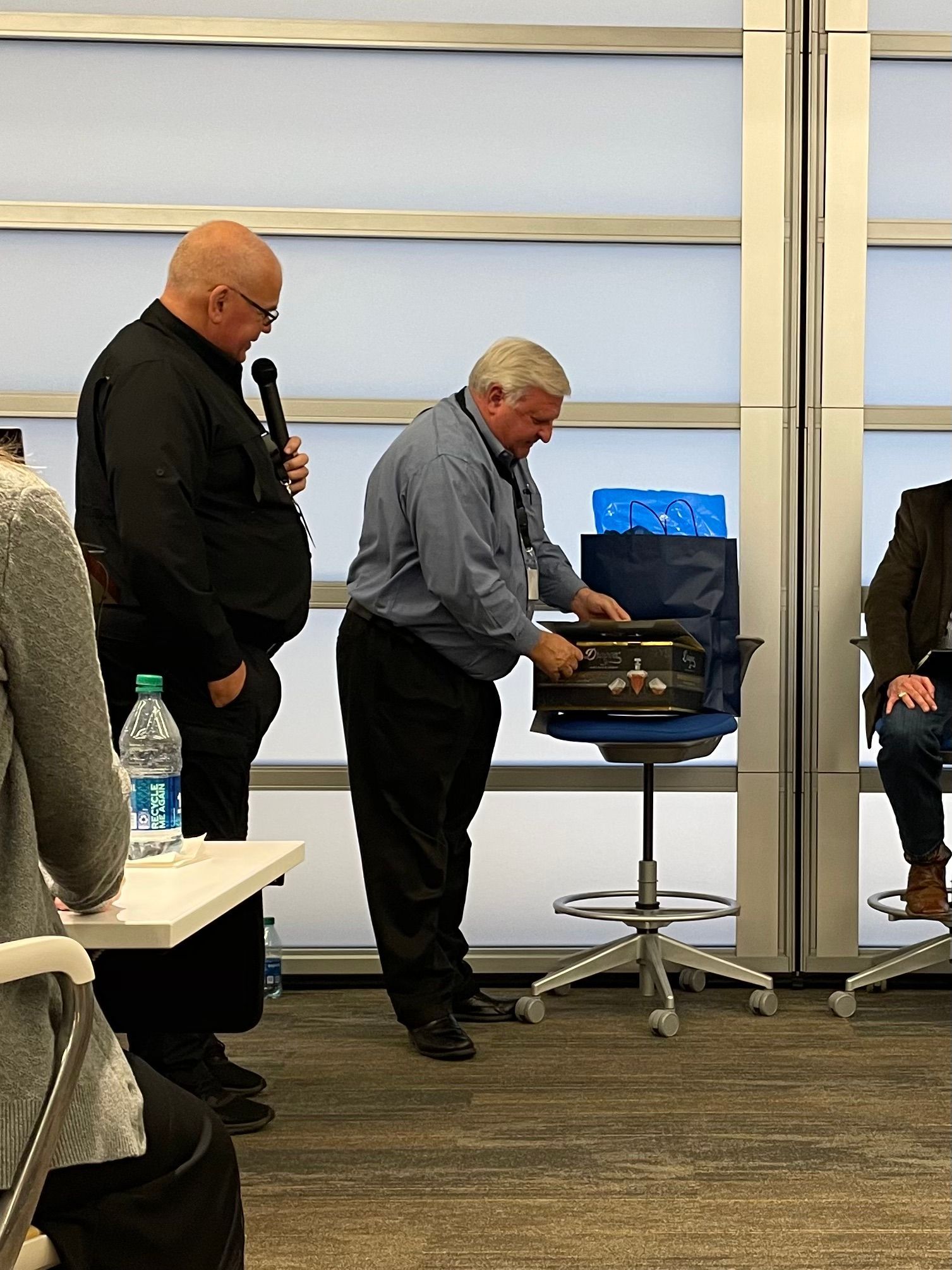 Jim Oberkircher and Paul Pastusek looking at gift