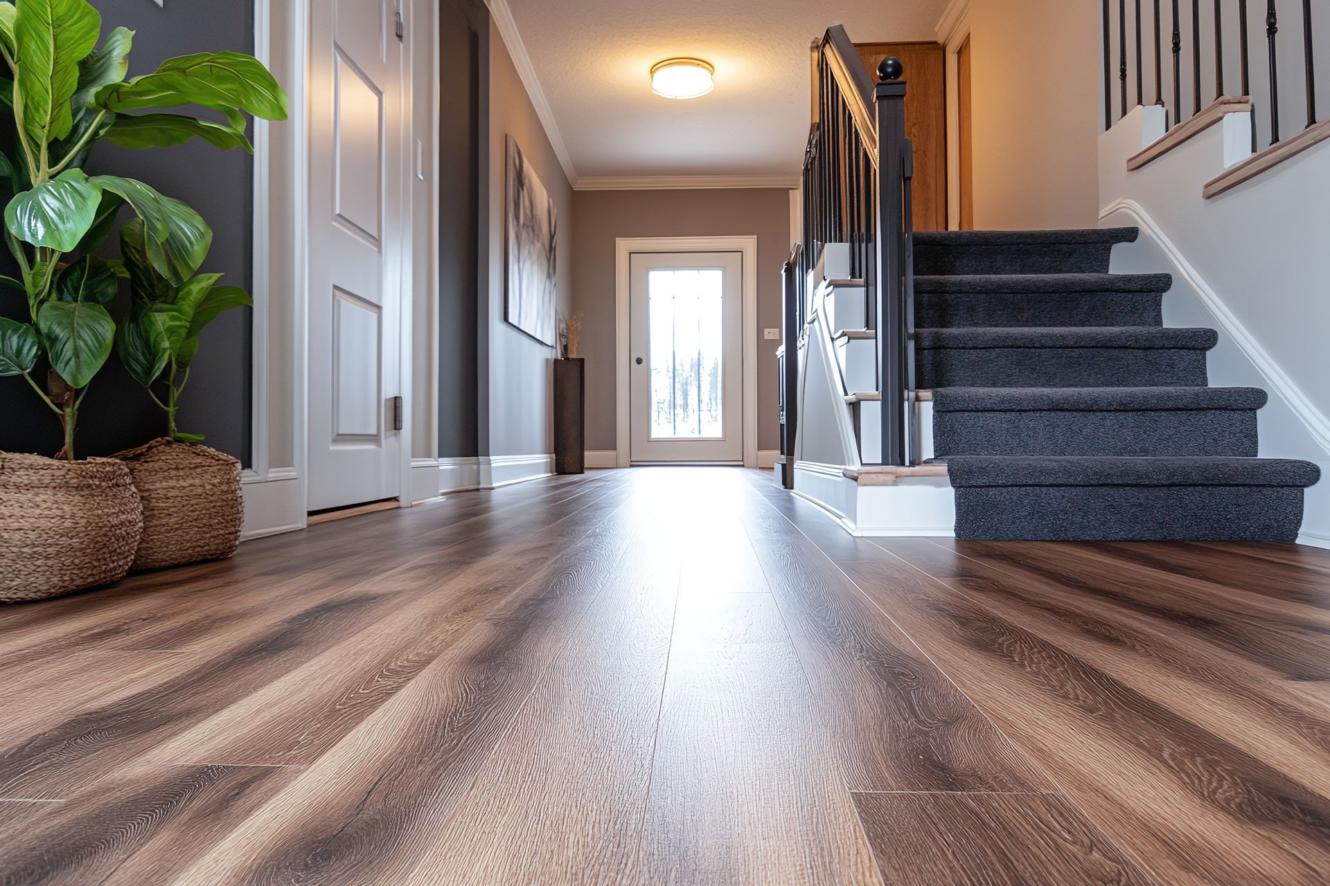 Luxury vinyl plank LVP installation in Deerfield Illinois home, Lake Cook Hardwood and Flooring crew completing vinyl floor installation in kitchen and living area
