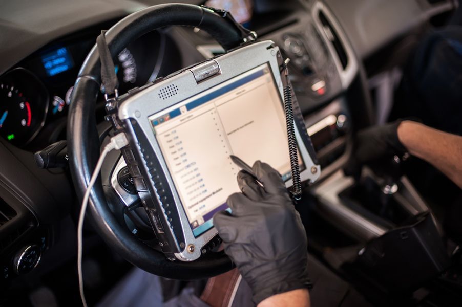 A Person Is Using a Tablet in A Car — GT Auto Center in Tweed Heads South, NSW