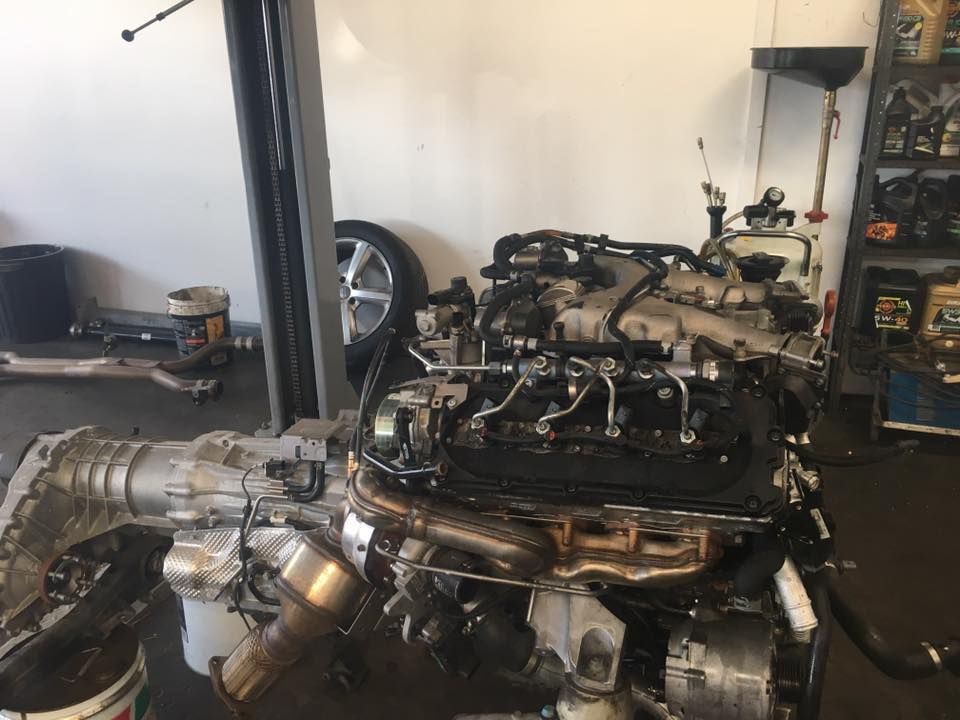 A Car Engine Is Sitting on A Lift in A Garage — GT Auto Center in Tweed Heads South, NSW
