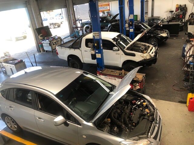 A Row of Cars Are Sitting in A Garage with Their Hoods Open — GT Auto Center in Tweed Heads South, NSW