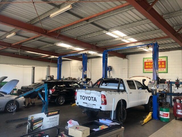 A Toyota Truck Is Sitting on A Lift in A Garage — GT Auto Center in Tweed Heads South, NSW