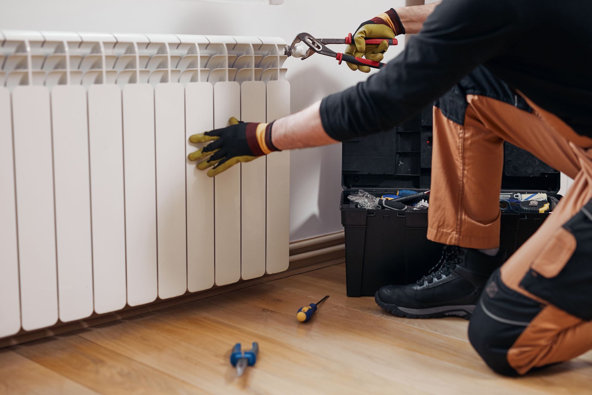 Martin Heating mechanic fixing home radiator in Texas during the winter.