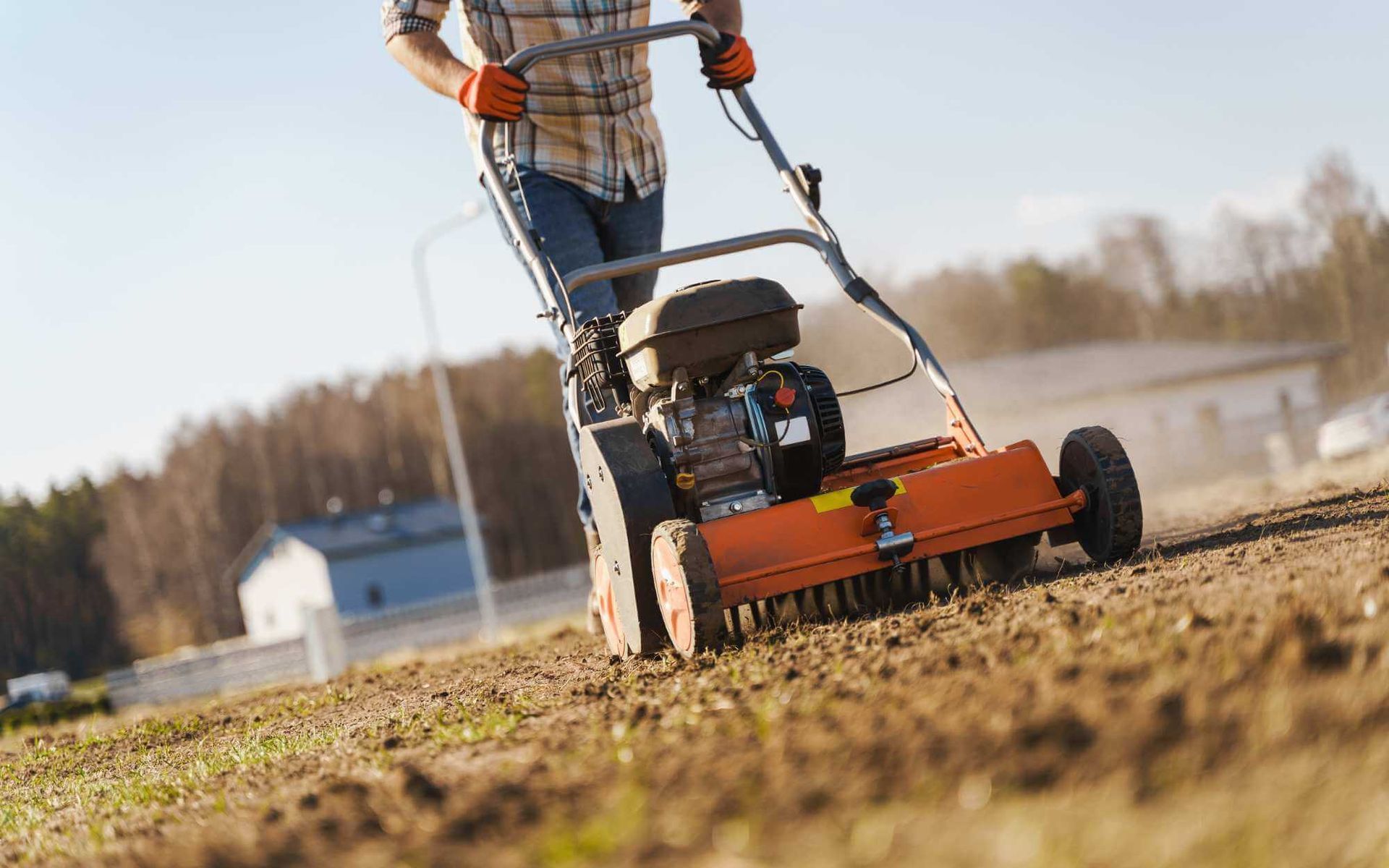 lawn aerator being operated by a Real Tree Team member