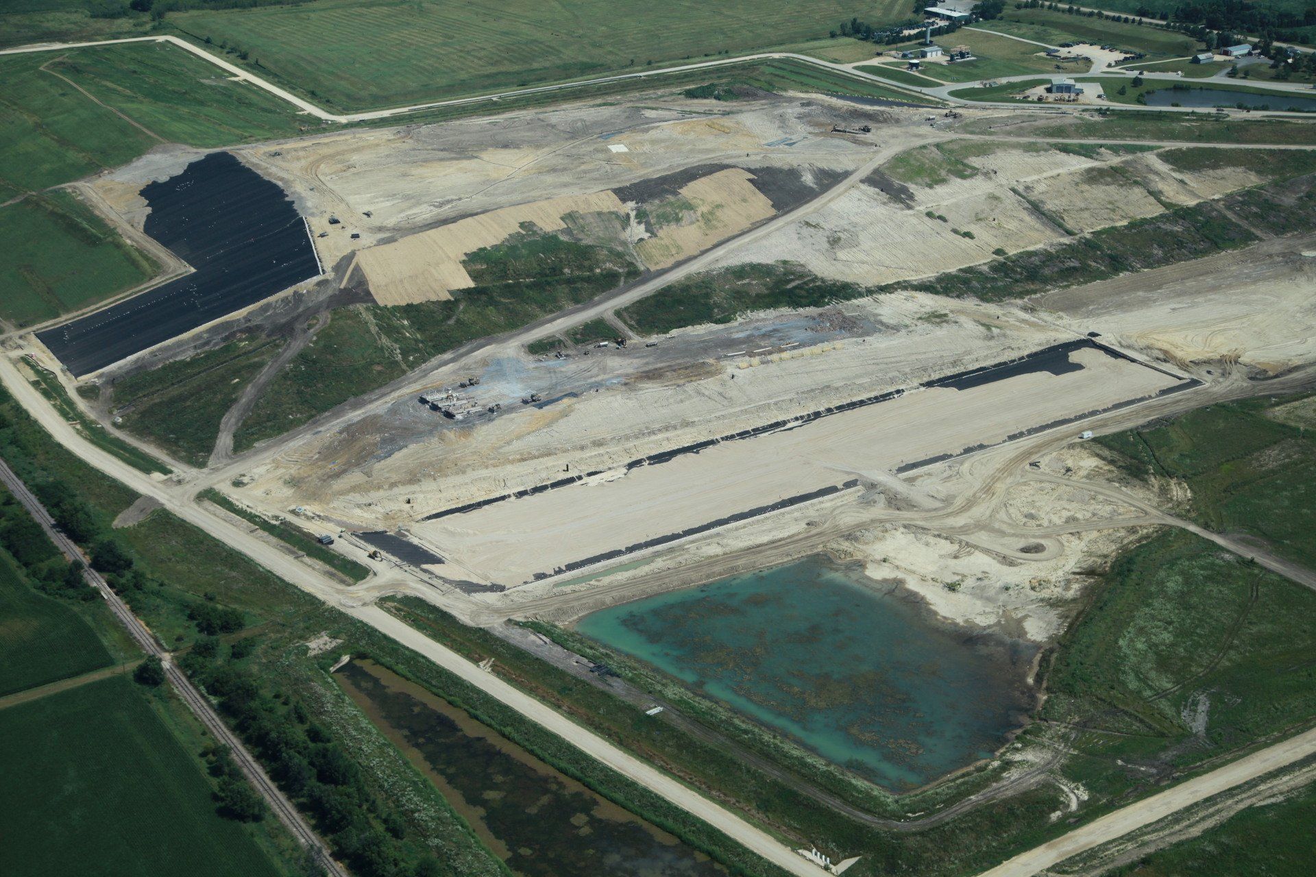 An aerial view of a construction site with a lot of dirt and grass