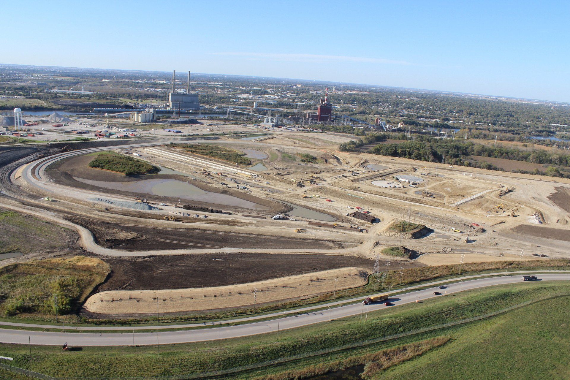 An aerial view of a construction site with a city in the background