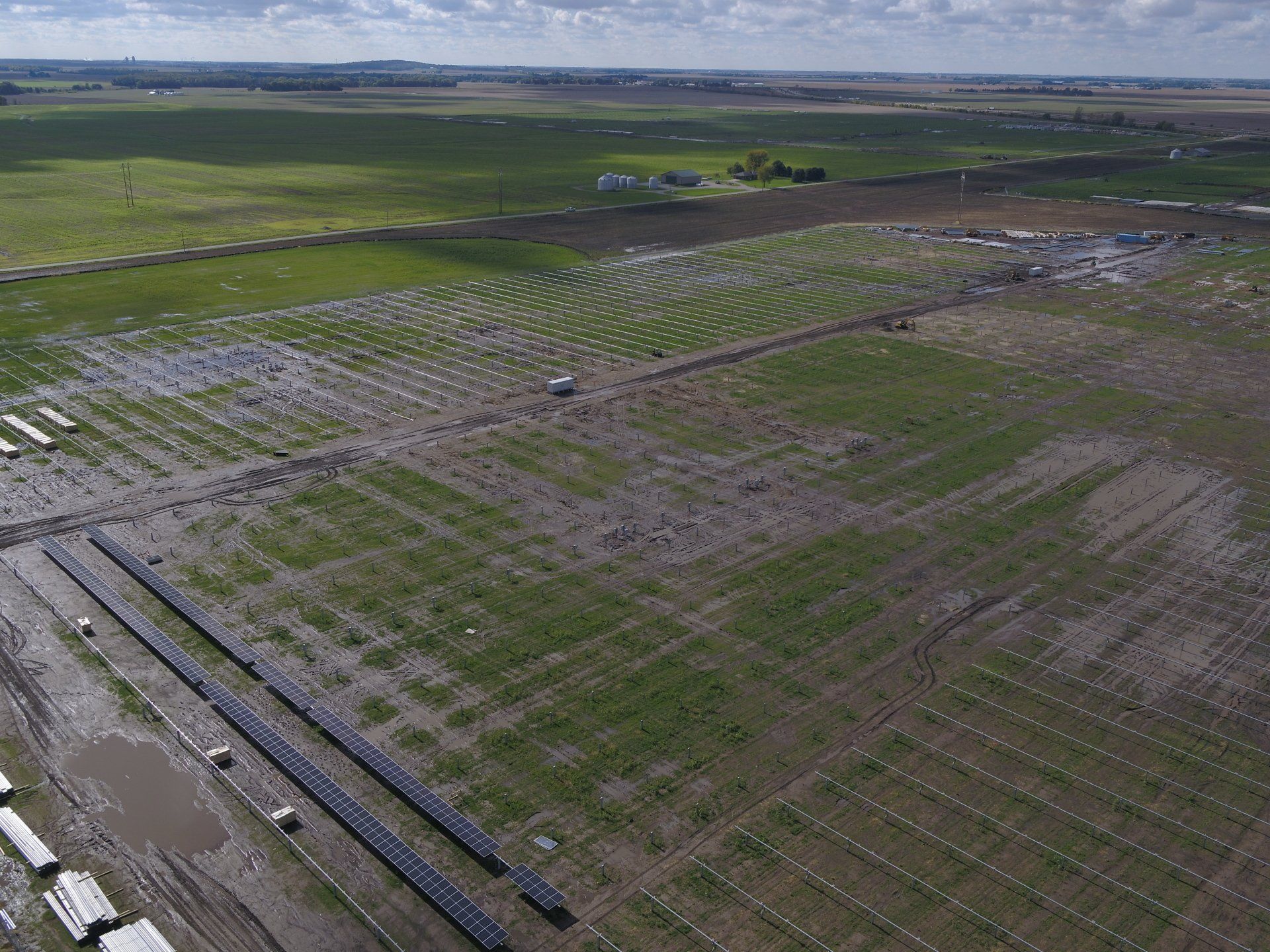 An aerial view of a flooded field with a lot of trees in the background.