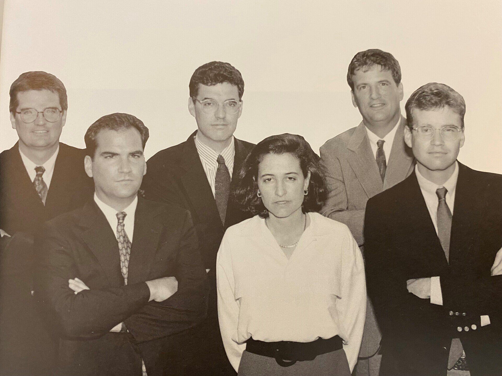 A group of people posing for a picture with their arms crossed