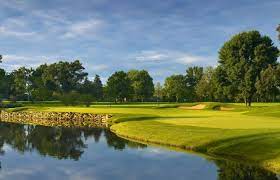 There is a lake in the middle of a golf course.
