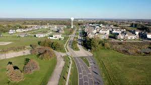An aerial view of a road with a water tower in the background.