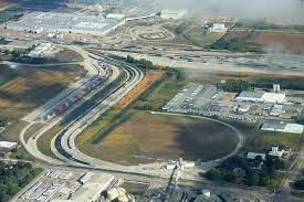 An aerial view of a highway intersection in a city.