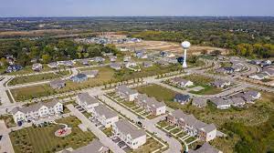 An aerial view of a residential area with a water tower in the distance.
