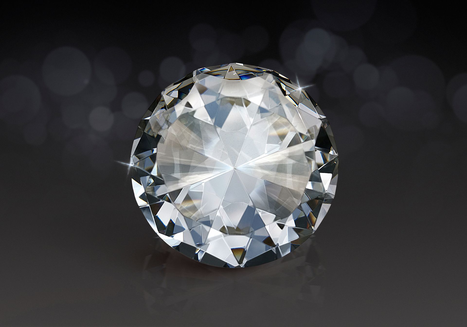 A close up of a diamond on a black background.