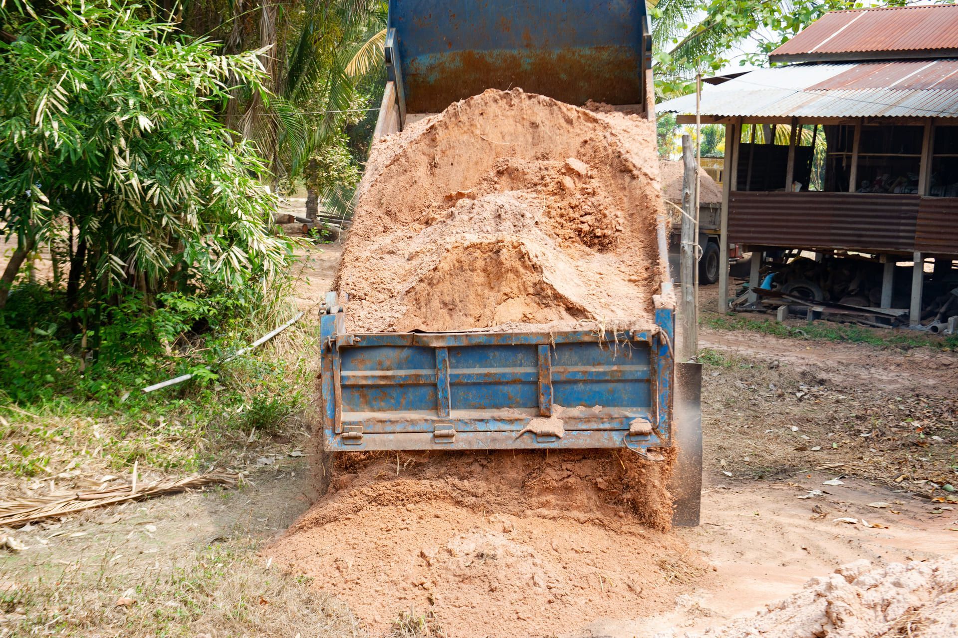 The truck is loading the soil to fill the ground
