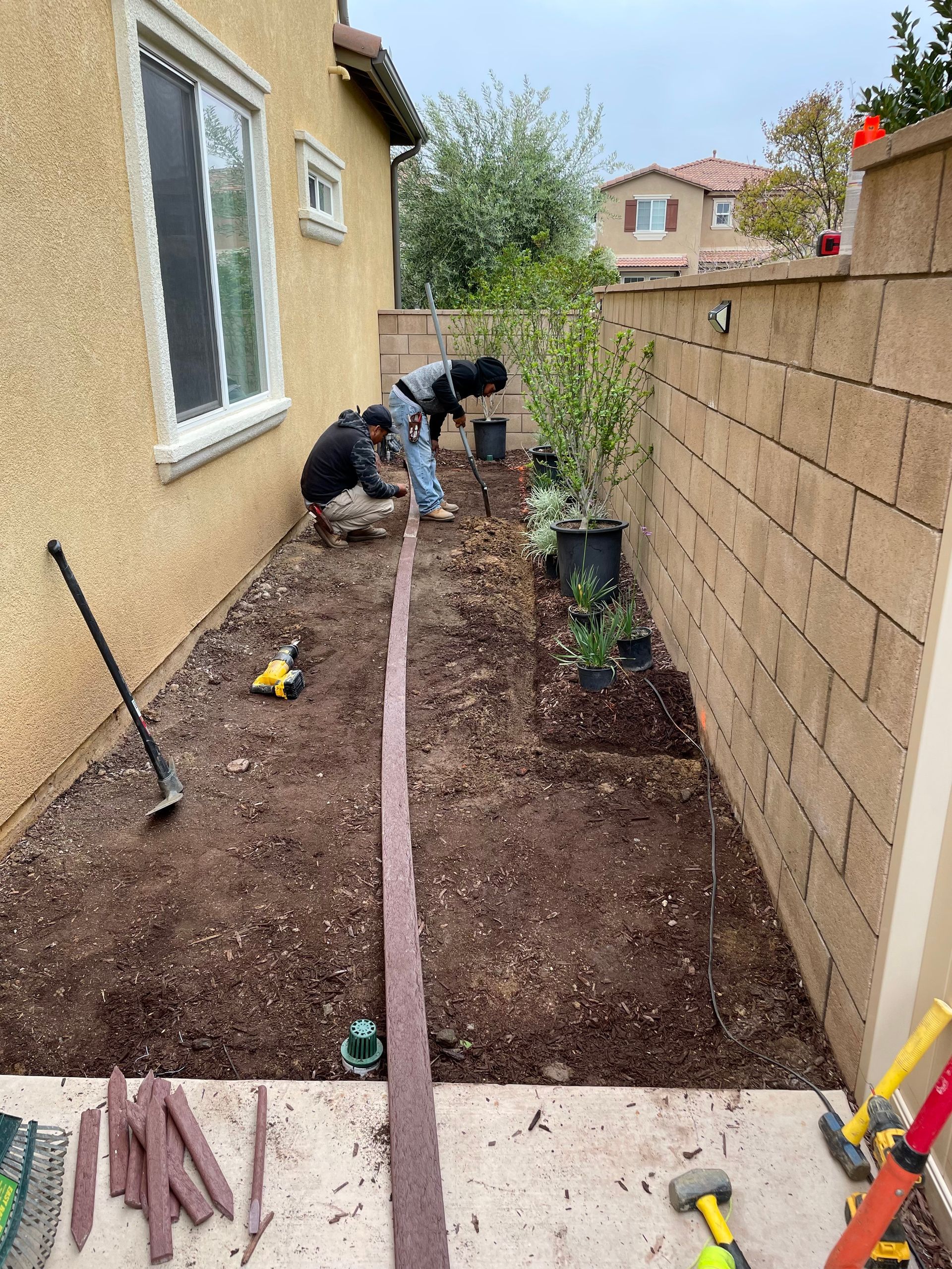 landscapers working in backyard