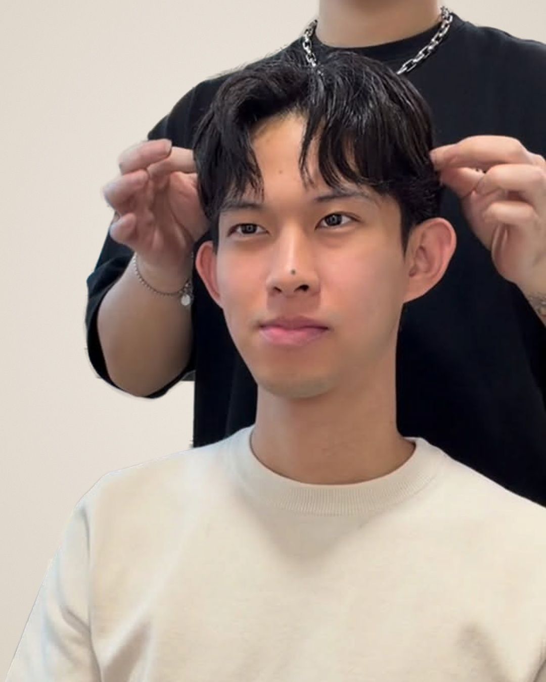 Man with a textured men's perm and wavy curtain fringe, styled by Nicholas at Kimage Salon Singapore