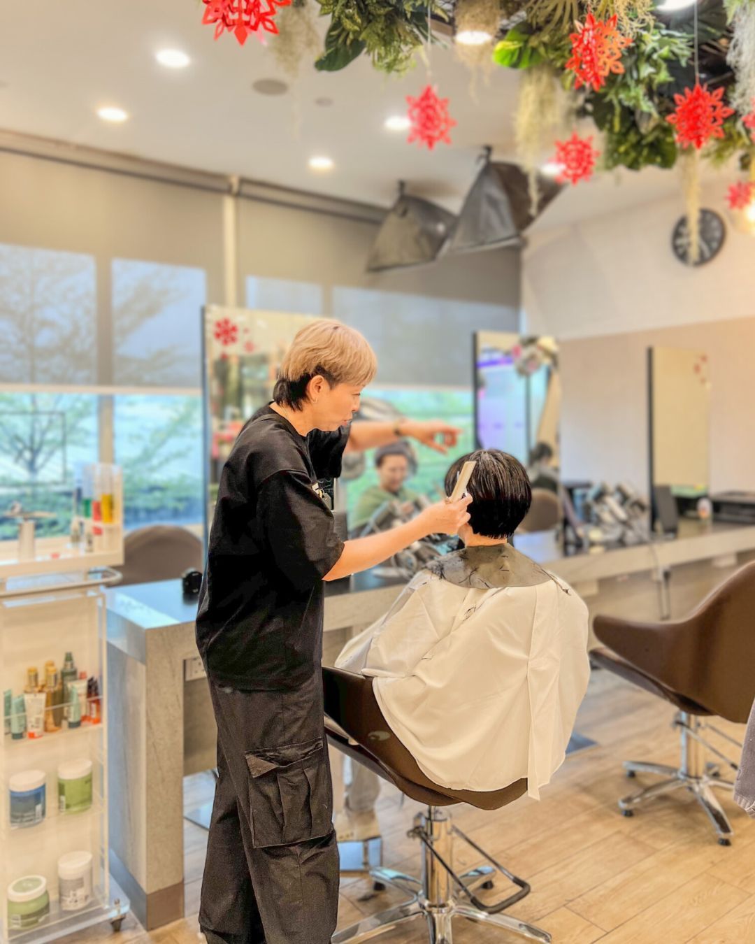 A photo of our hairdresser working on our client's hair