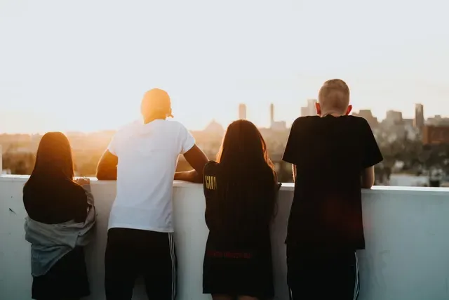 Digital Future First A group of people are standing on a balcony looking at the city.