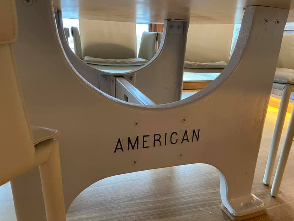 American Airlines cabin seat divider with the word “AMERICAN” visible below.