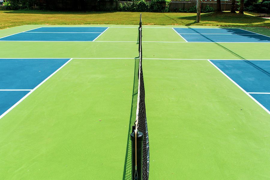 a blue tennis court with white lines and a net