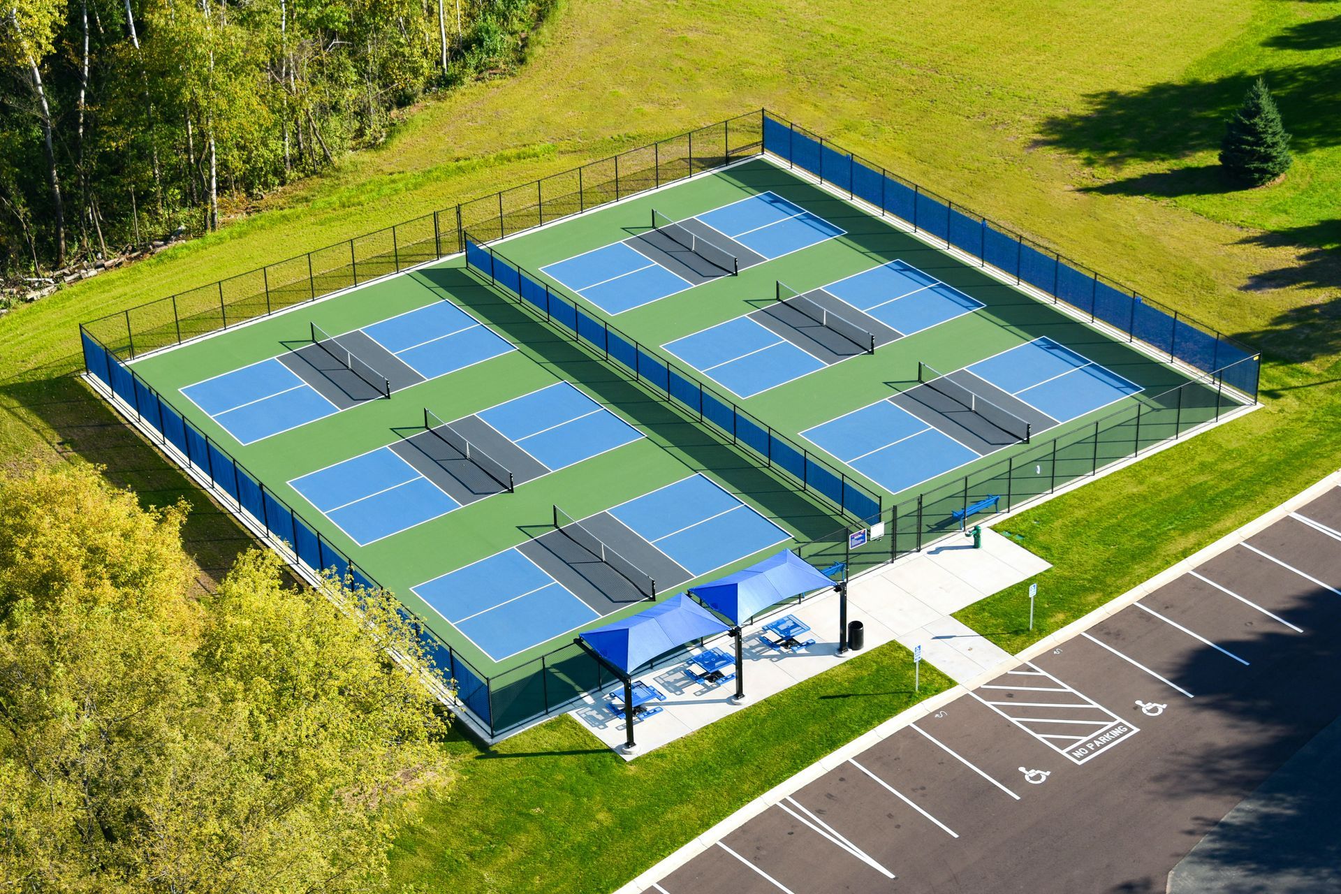 an aerial view of a blue tennis court with white lines