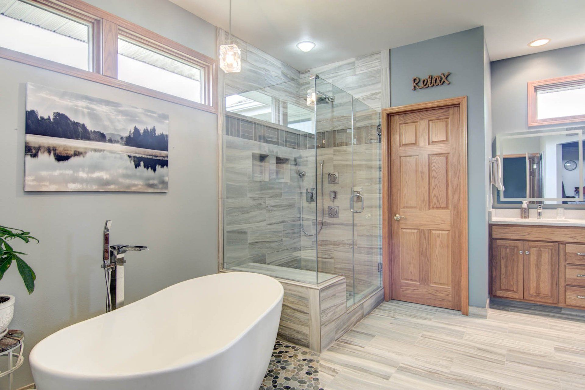 A bathroom with a bathtub and a walk in shower.