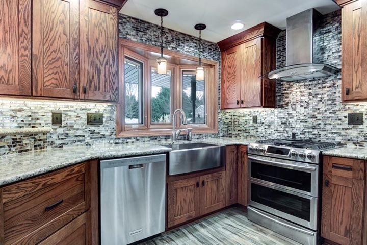 A kitchen with stainless steel appliances and wooden cabinets.