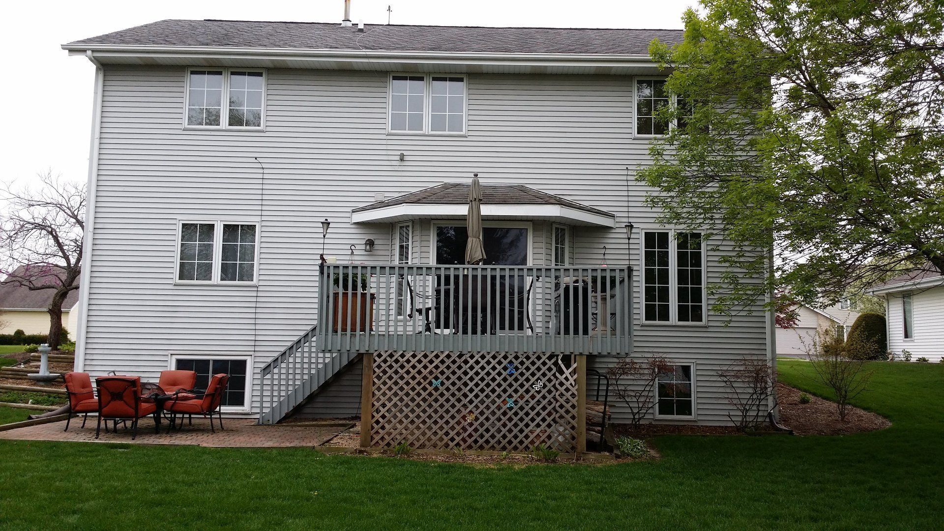 The back of a house with a large deck and stairs