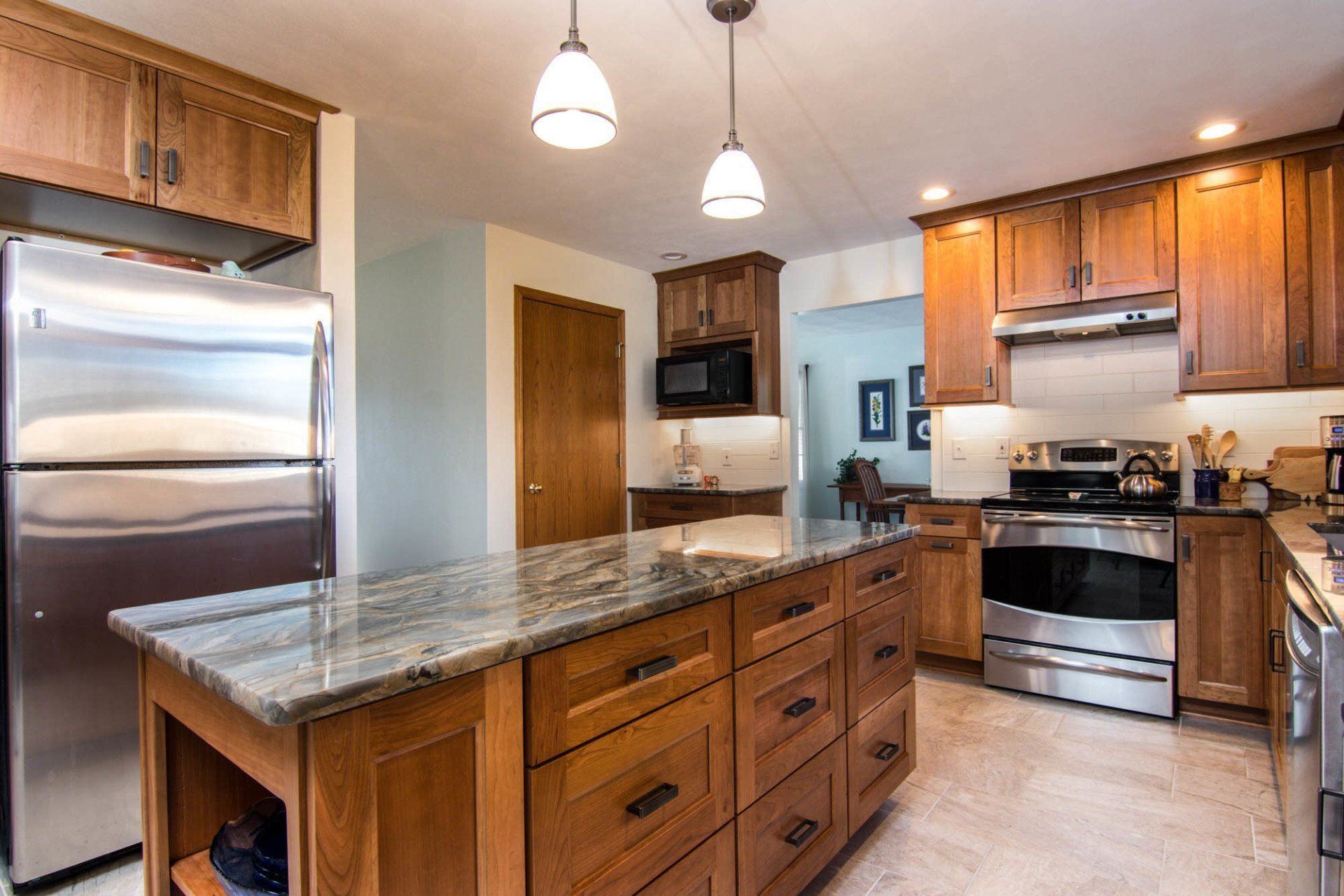 A kitchen with stainless steel appliances and wooden cabinets.