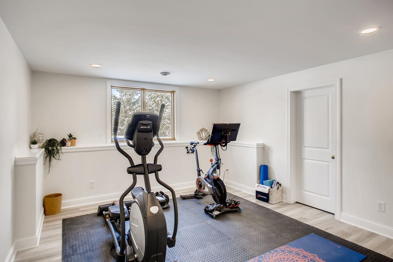 There is an elliptical machine in the middle of the room.