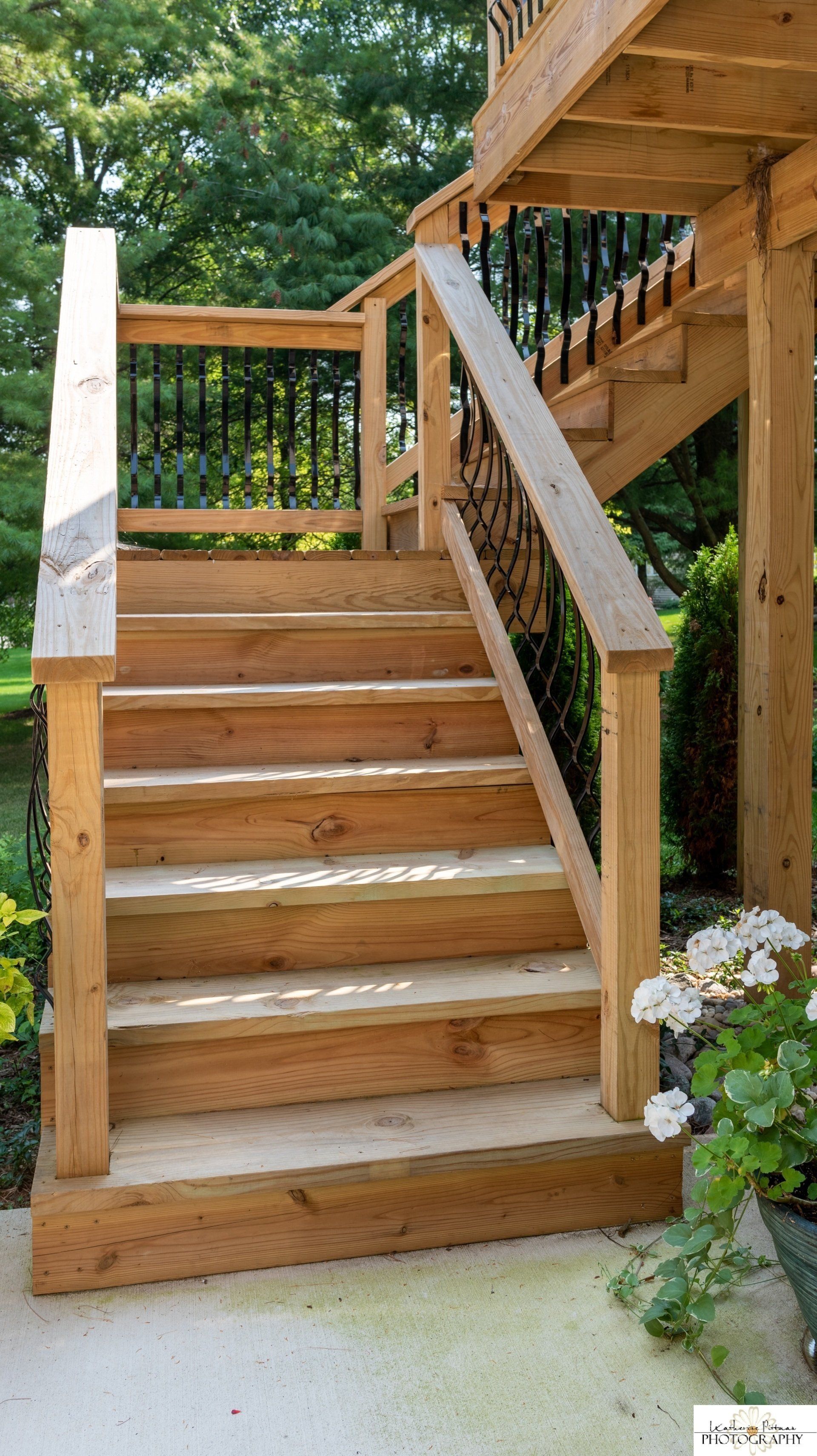 A set of wooden stairs leading up to a deck.