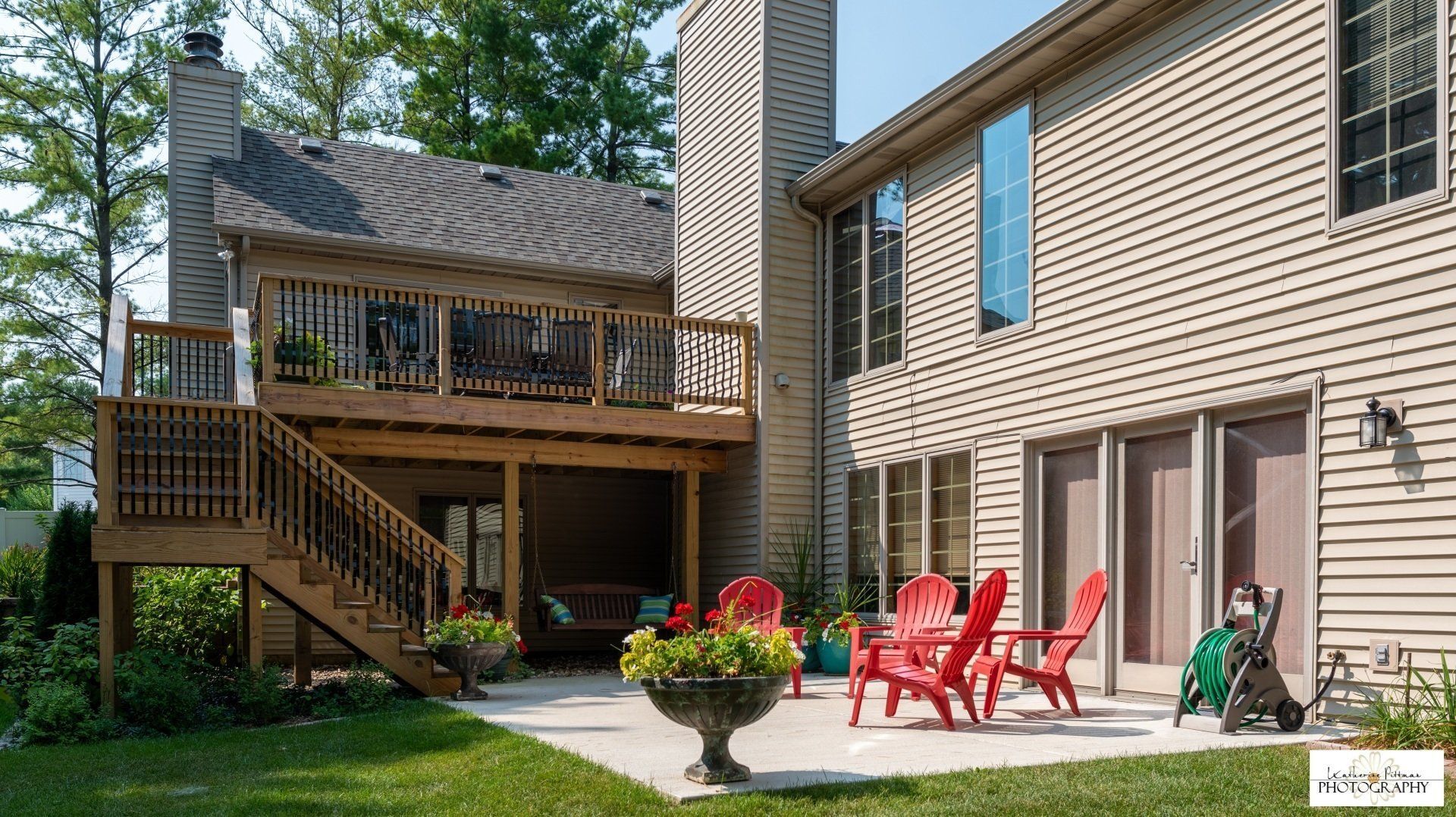 A large house with a large deck and patio area