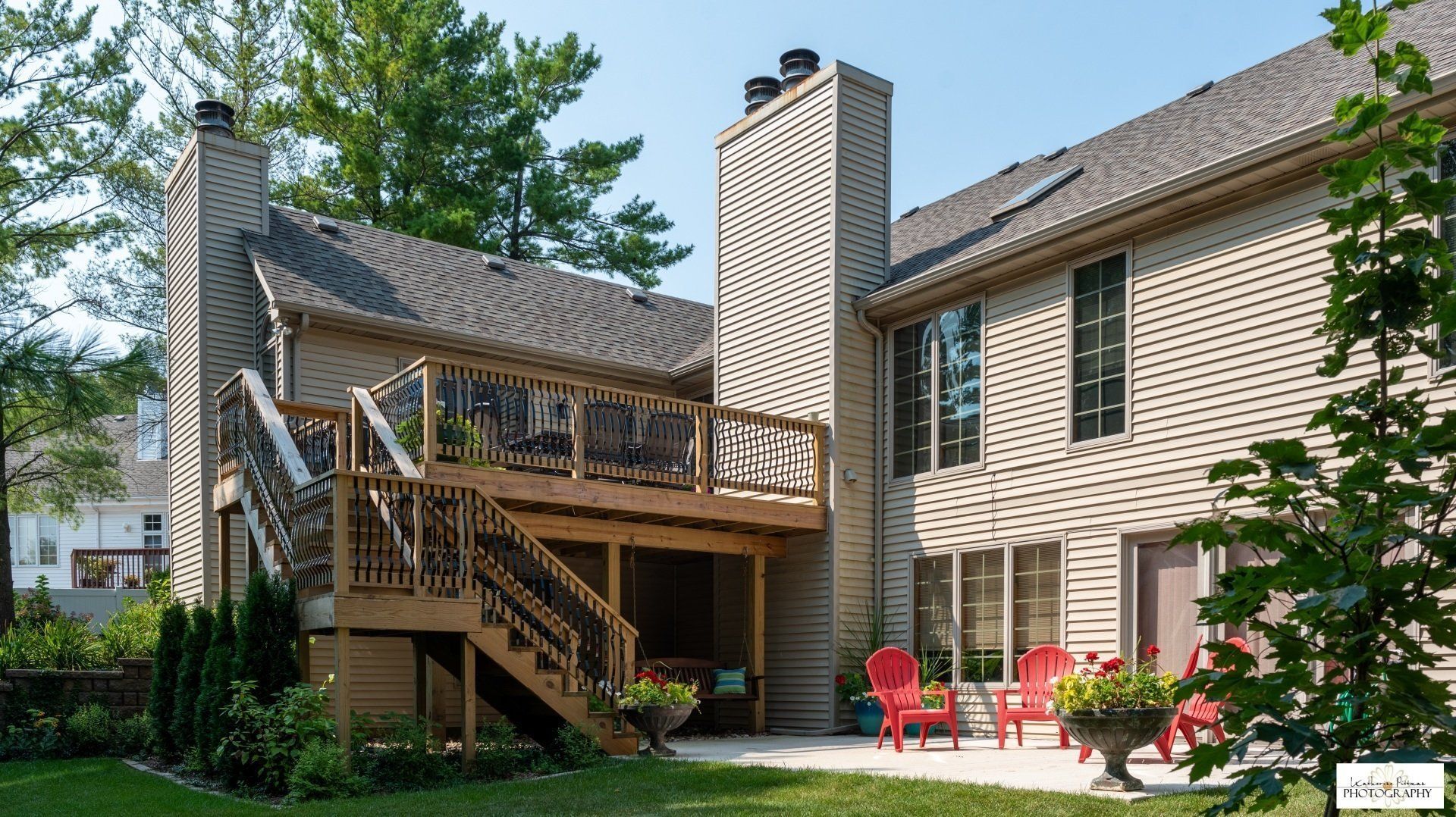 A large house with a large deck and stairs