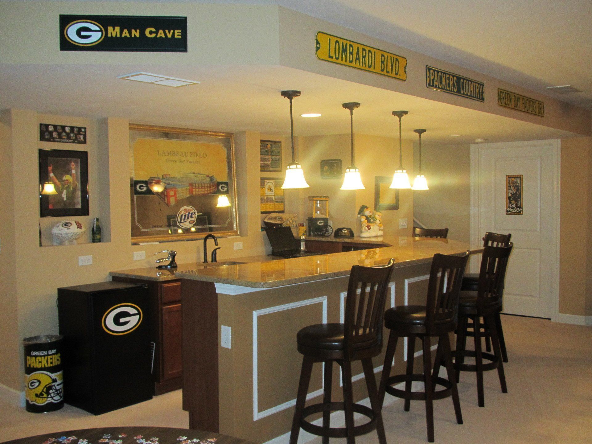 A man cave with a sign that says man gave