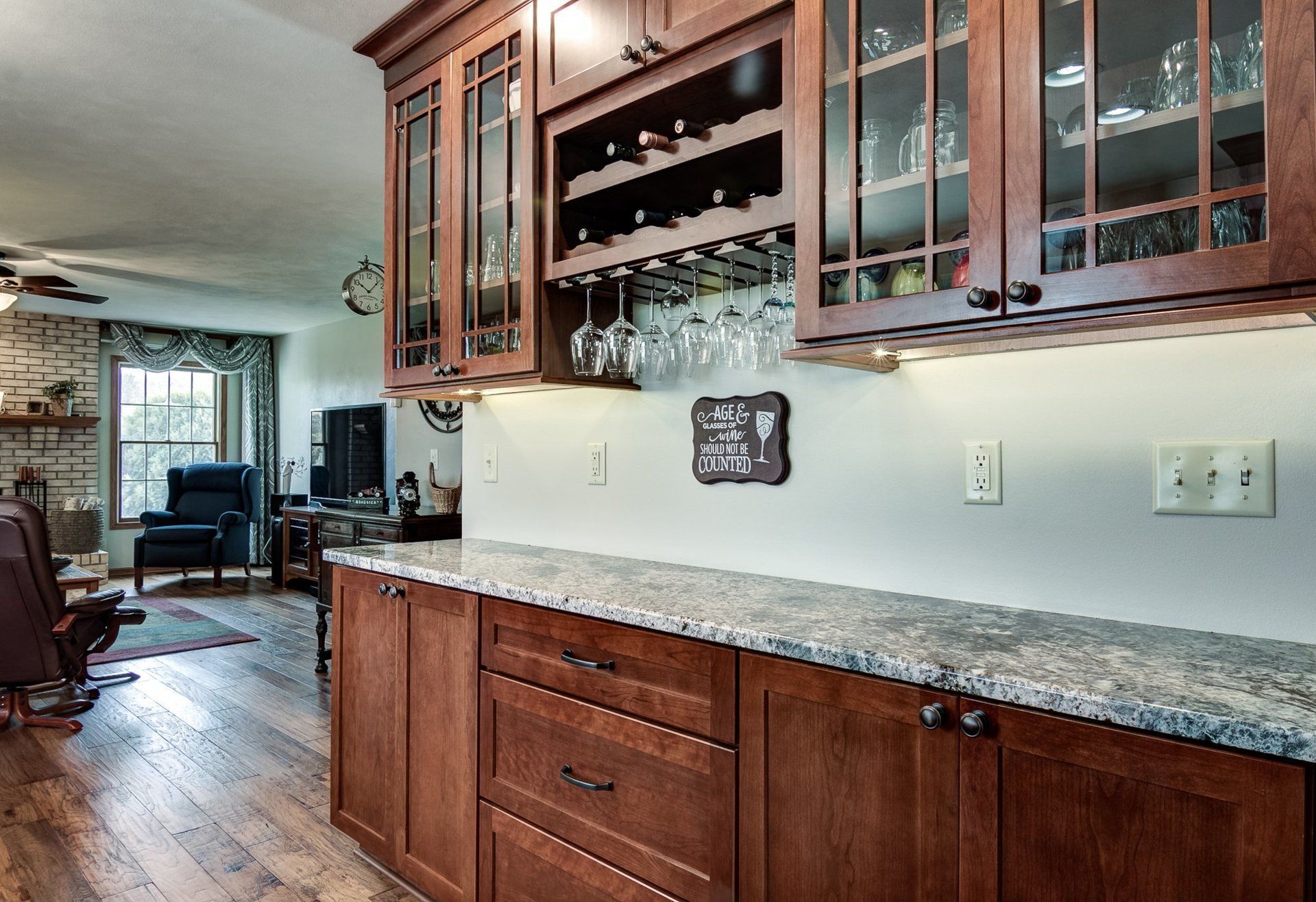 A kitchen with wooden cabinets and granite counter tops.