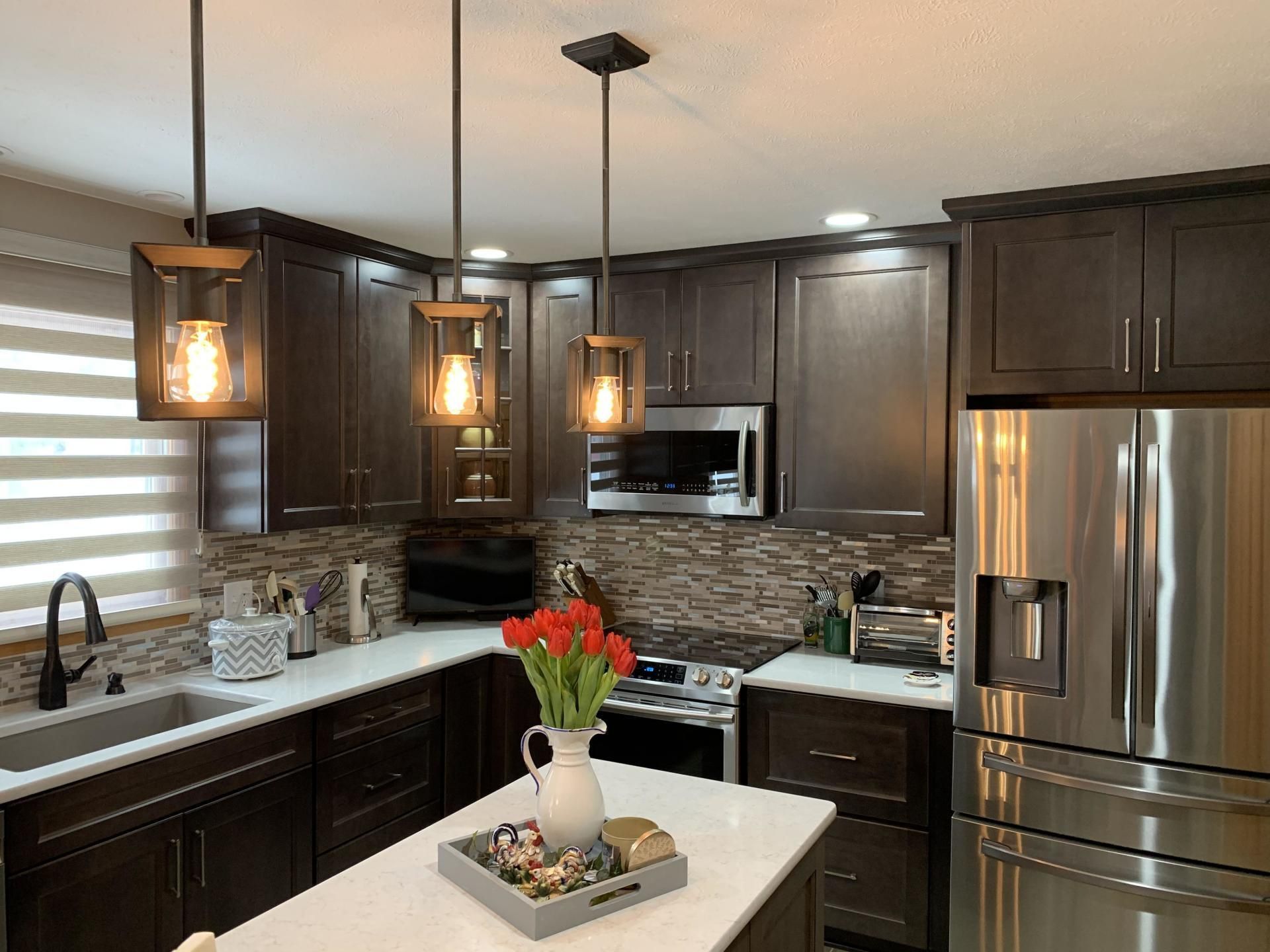 A kitchen with stainless steel appliances and wooden cabinets