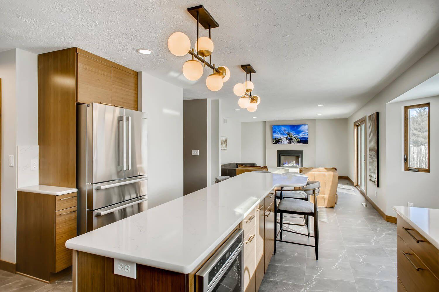 A kitchen with a large island and stainless steel appliances.