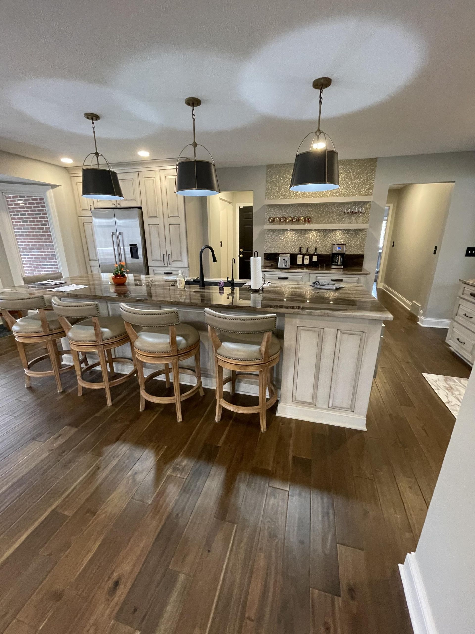 A kitchen with a large island and stools