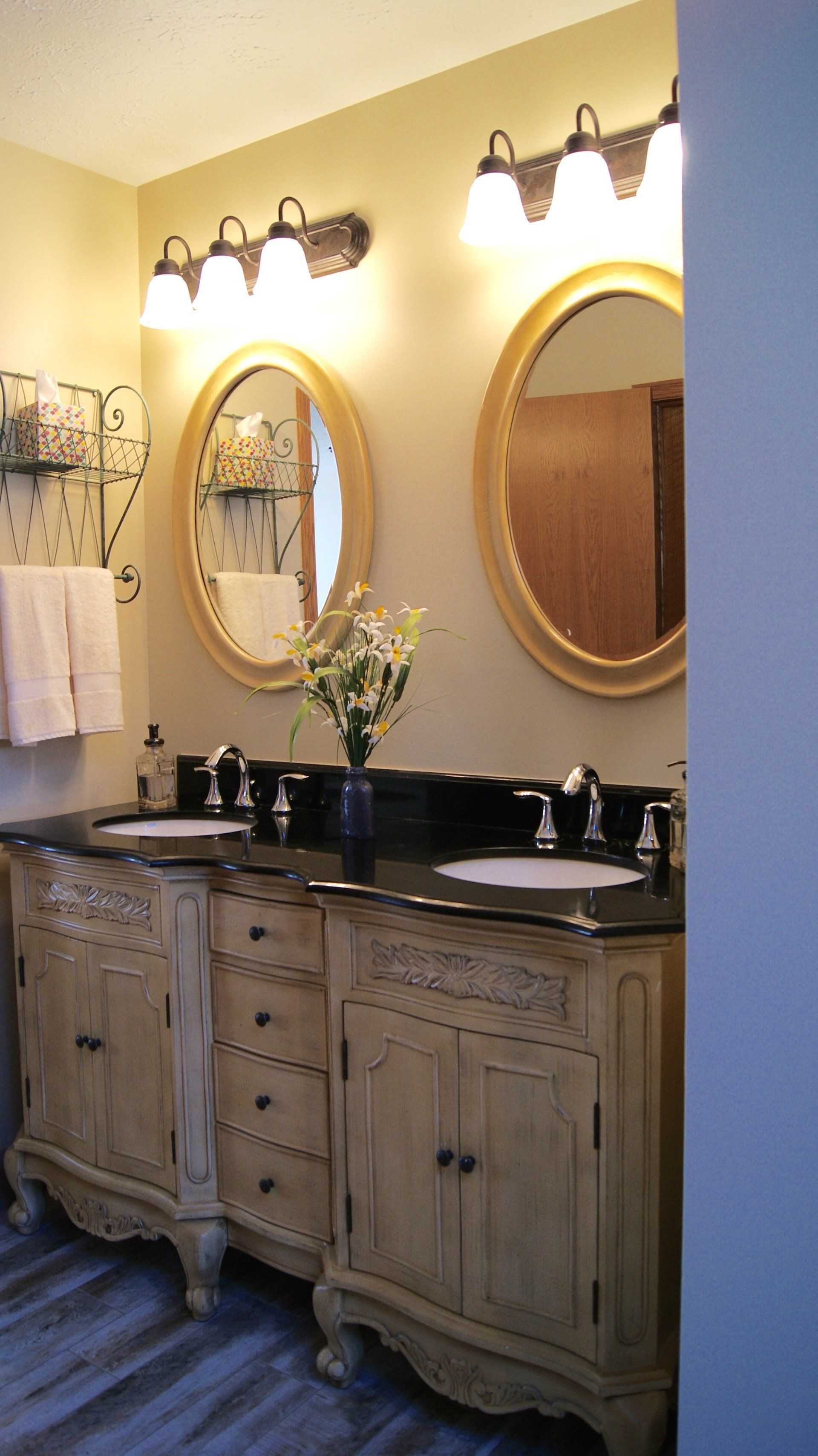 A bathroom with two sinks and two mirrors.